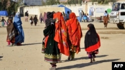 Afghan refugees arrive from Pakistan at the border in the Spin Boldak district of Kandahar Province on December 3.