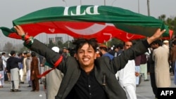 Supporters of Imran Khan's Pakistan Tehreek-e-Insaf (PTI) party block a highway as they protest against the election results in Peshawar on February 12.