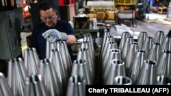 An employee handles 155mm caliber shells after the manufacturing process at the the Scranton Army Ammunition Plant in Scranton, Pennsylvania, on April 16.