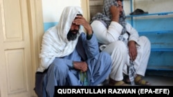 Relatives attend the funeral of an Afghan man who was killed in the suicide attack in Kandahar on March 21.