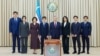 Uzbek President Shavkat Mirziyoev (center) and his family members pose during the early presidential election in Tashkent on July 9.