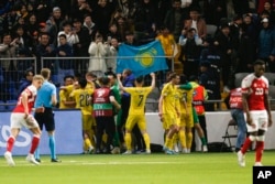 Kazakhstan players celebrate their victory over Denmark in Astana on March 26.