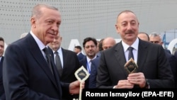 Turkish President Recep Tayyip Erdogan (left) and Azerbaijani President Ilham Aliyev attend an opening ceremony of the new international airport in Zangilan, Azerbaijan, on October 20, 2022.