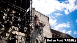 Workers clear rubble from the upper floors of a Ukrainian power plant damaged in a Russian attack on June 20.