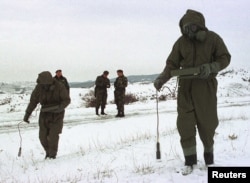 Yugoslav soldiers measure radioactivity levels near the southern Serbian town of Presevo in 2001 after warplanes fired thousands of depleted uranium rounds during the NATO Bombing of Yugoslavia.