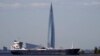 An oil tanker in the Gulf of Finland passes the Lakhta Center skyscraper, the headquarters of Russian gas monopoly Gazprom, in St. Petersburg, Russia, in June 2023. 