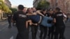 Armenian police officers detain a protester outside the government building in Yerevan on August 8. Tensions between Baku and Yerevan have escalated sharply in recent days as both sides accuse the other of cross-border gunfire and violating agreements.