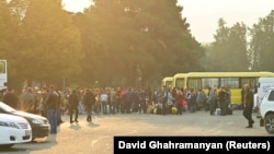 Residents gather next to buses in central Stepanakert before leaving Nagorno-Karabakh amid a mass exodus of the ethnic Armenian population last week.