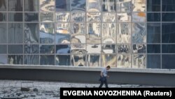 A man walks through debris next to a damaged office building in Moscow following a drone attack on August 1.
