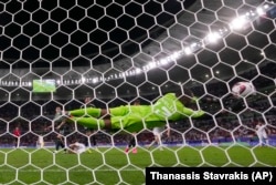 Tajikistan's Vahdat Hanonov scores his side's opening goal during the Asian Cup match on January 28.