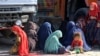 Afghan refugee women and children sit at a registration center after arriving from Pakistan near the Afghanistan-Pakistan border in the Spin Boldak district of Kandahar Province, Afghanistan, on November 28.