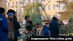 Labor migrants on a street in Mariupol