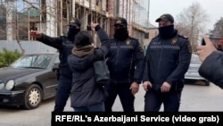 Police in Baku during a raid on the Toplum TV channel on March 6.