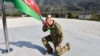 Authoritarian Azerbaijani leader Ilham Aliyev kneels after raising his country's flag in the former breakaway region of Nagorno-Karabakh on October 15. 