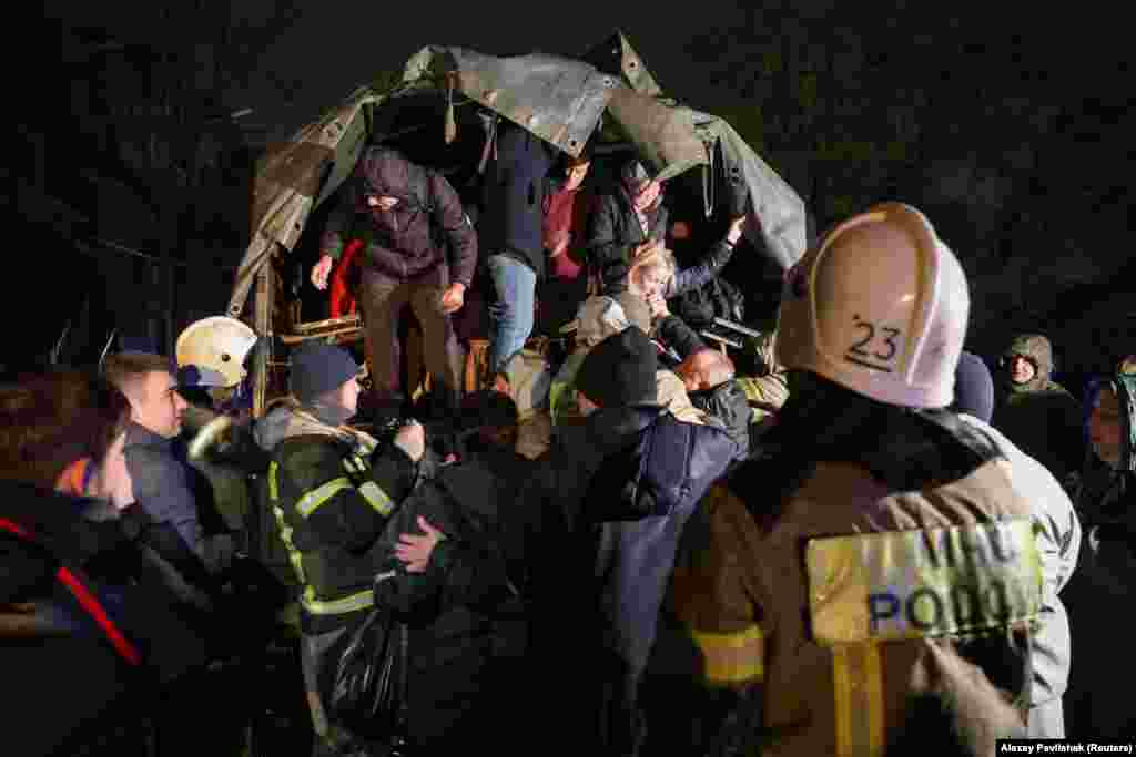 Rescuers assist those whose homes were flooded.