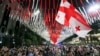 Demonstrators wave a giant Georgian national flag at the parliament building during an opposition protest against the "foreign agents" law in Tbilisi in late May.