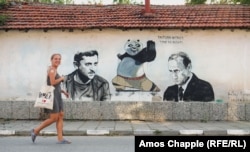 Anna Kossyk walks past a wall she and other Polish art students painted in 2022.