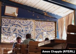 Shrapnel damage is seen in a cafe that recently reopened near Irpin.