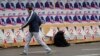 A man looks at campaign posters for opposition candidate Shalva Natelashvili in Tbilisi on October 22.