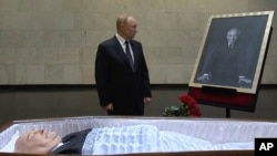 Russian President Vladimir Putin pays his last respects near the coffin of former Soviet leader Mikhail Gorbachev at the Central Clinical Hospital in Moscow on September 1.