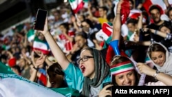 Iranian women cheer their World Cup soccer team at Tehran's Azadi Stadium on June 20.