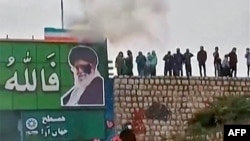 A screen grab from a video taken earlier this month that apparently shows protesters throwing a small explosive device at a banner depicting the Islamic republic's Supreme Leader Ayatollah Ali Khamenei in the central city of Isfahan. 