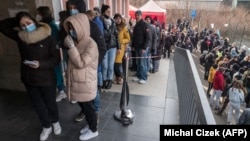 Ukrainian refugees stand in line to file for residence permits at the headquarters of Prague's foreigner's police on March 2.