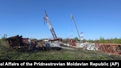 Two destroyed radio antennas lie on the ground in Maiac in Moldova's breakaway Transdniester region on April 25.