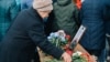 A woman in Buryatia pays her respects to a Russian serviceman who died in the invasion of Ukraine. 