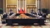 Chinese President Xi Jinping (fourth from right) and Russian President Vladimir Putin (fourth from left) attend a joint meeting in Beijing on February 4 where they declared a "no limits" partnership. 