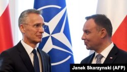 NATO Secretary-General Jens Stoltenberg (left) and Polish President Andrzej Duda speak in Warsaw on May 28.