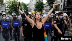 Her viral moment: Liana Georgieva blows her whistle as riot police try to disperse her and others gathering for a pride parade in central Istanbul on June 26.