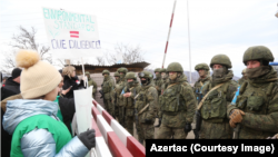 Russian peacekeepers are confronted by Azerbaijanis blocking the road connecting Nagorno-Karabakh to Armenia last week.