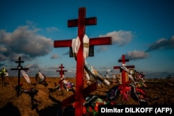 Memorial crosses mark new graves at a cemetery in Kherson on December 28.