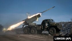 A Ukrainian Army Grad multiple-rocket launcher fires at Russian positions on the front line near Soledar on January 11.