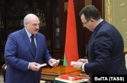 Belarusian Health Minister Dzmitry Pinevich (right) presents a batch of Russian Sputnik V vaccine to Alyaksandr Lukashenka in Minsk earlier this year.