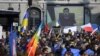 Ukrainian President Volodymyr Zelenskiy is displayed on a giant screen after delivering a live voice message during a demonstration against the Russian invasion of Ukraine in front of the Swiss parliament in Bern on March 19, 2022. 