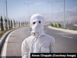 A masked gardener who was working near the wedding palace. The mask is to protect his face from the scorching summer sun. Temperatures in the country can climb to 50 degrees Celsius.