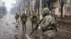 Russian soldiers patrol the captured Levoberezhny district of Mariupol last month.