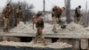 Ukrainian soldiers build a bunker with sand during intense shelling in Bakhmut on December 26.