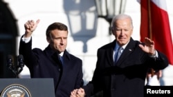 U.S. President Joe Biden (left) greets French President Emmanuel Macron at the White House in Washington on December 1. 