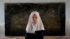 Eight-year-old Mahtab poses in her classroom at the Abdul Rahim Shaheed School in Kabul on April 23. After seizing power in August 2021, the Taliban banned high school education for girls.