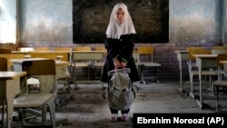 Eight-year-old Mahtab poses in her classroom at the Abdul Rahim Shaheed School in Kabul on April 23. After seizing power in August 2021, the Taliban banned high school education for girls.