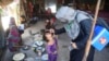 A health worker administers polio vaccine drops to a child during a vaccination campaign in Karachi, Pakistan, on November 28, 2022. 