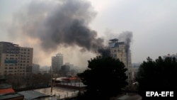 Smoke billows from a guesthouse after an attack in Kabul in December 2022.