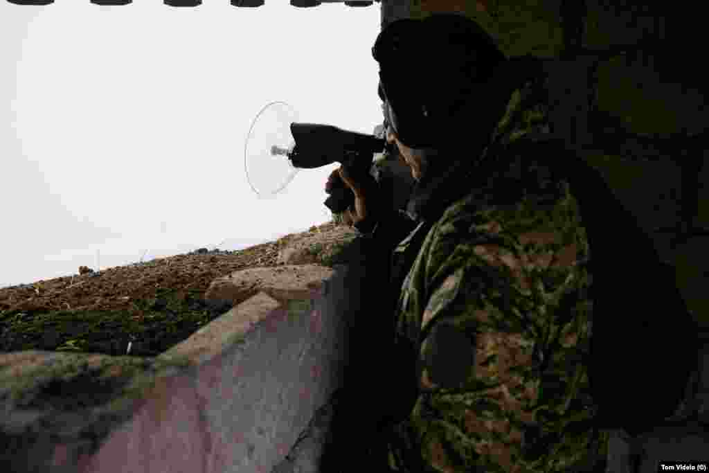 An Armenian soldier uses a listening device at a position near the Lachin blockade during a foggy day on December 21. At some points near the southeastern border, military outposts of Azerbaijan and Armenia are just meters apart. &nbsp; &nbsp;