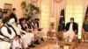 Pakistani Prime Minister Imran Khan (right) talks with Taliban co-founder Mullah Abdul Ghani Baradar (fifth left) during a meeting along with his delegation in Islamabad on December 18, 2020.