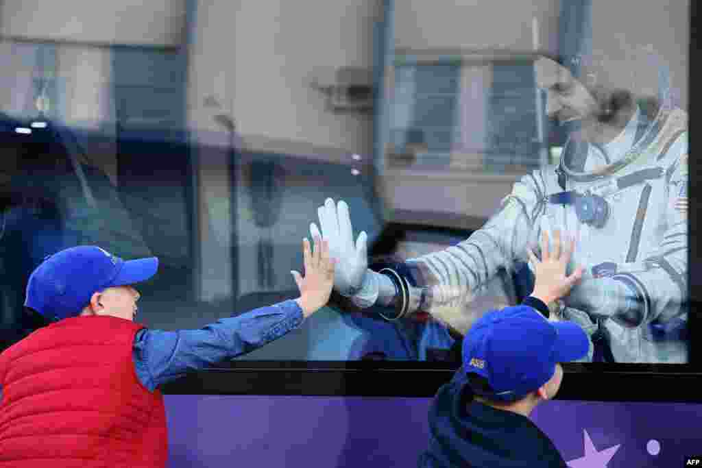 NASA astronaut Nick Hague gestures from inside a bus prior to the launch on October 11.