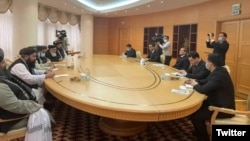 Taliban deputy leader Mullah Abdul Gani Baradar (left) holds talks with Turkmen Foreign Minister Rashid Muradov (right) in Ashgabat on February 6. 