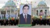 Crowds carry a giant portrait of President Gurbanguly Berdymukhammedov during Turkmen Independence Day celebrations in Ashgabat on October 27, 2009.